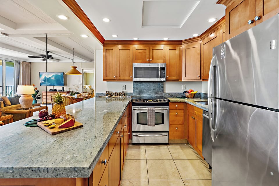 Your gourmet kitchen awaits with rich wood cabinetry, granite counters, and stainless-steel appliances. Perfect for preparing memorable meals together.