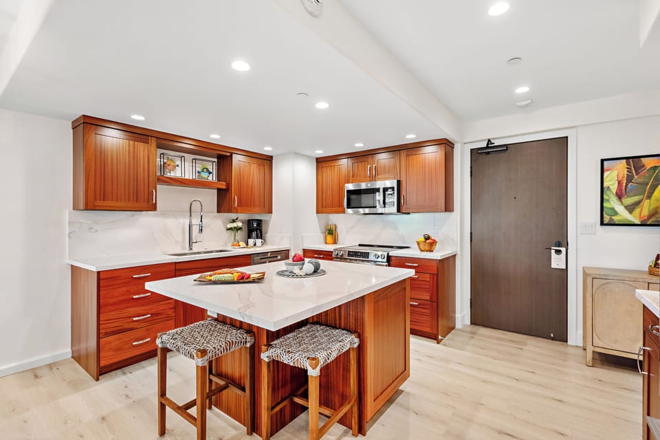 Your gourmet kitchen awaits with rich wood cabinetry, counters, and stainless-steel appliances. Perfect for preparing memorable meals together.