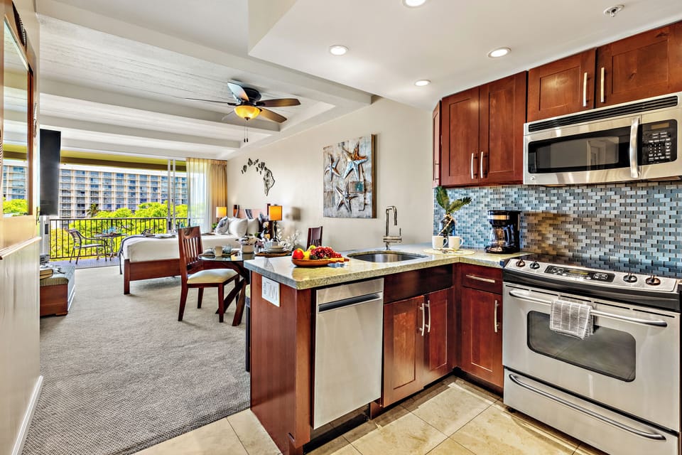 The open-concept kitchen seamlessly connects to the dining and living areas, creating the perfect space for gathering, entertaining, and making lasting vacation memories.