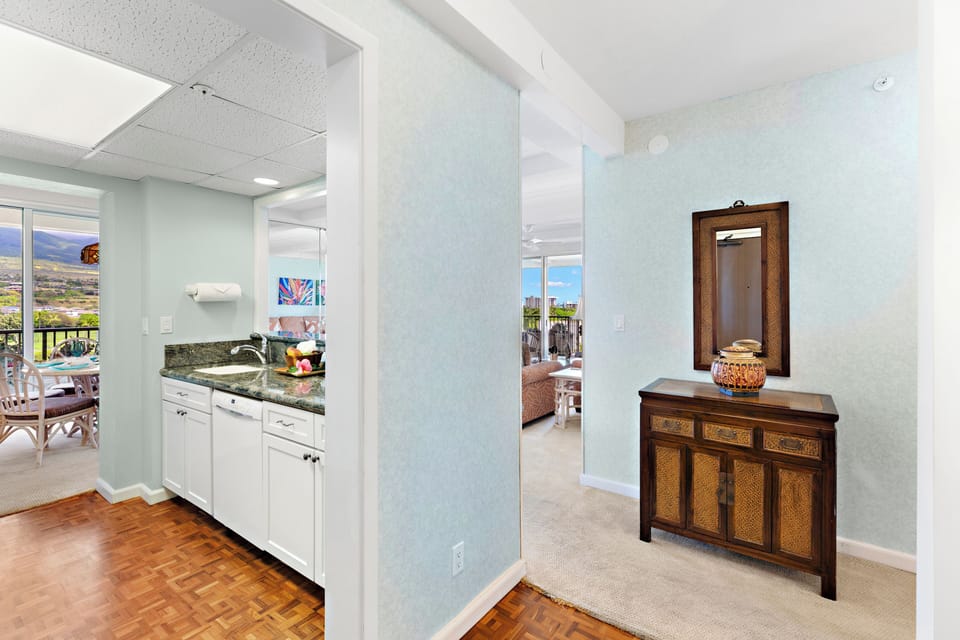 Seamless transition from kitchen to living areas, highlighted by clean finishes, warm flooring, and decorative accent furnishings.