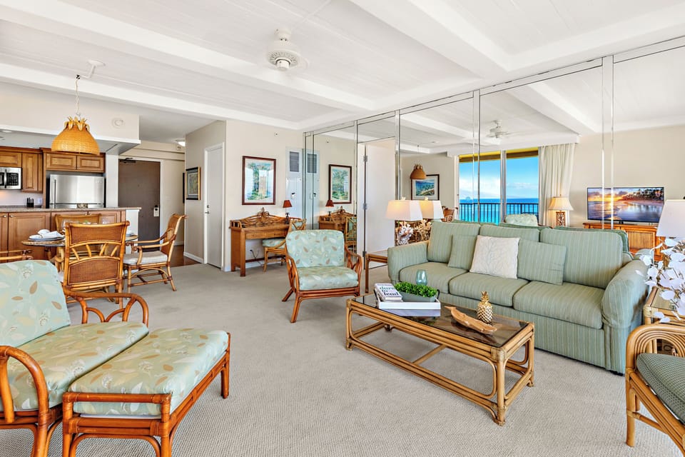 Bright, airy living room with a cozy sectional sofa (not equipped with a sofa sleeper), warm accents, and serene outdoor views