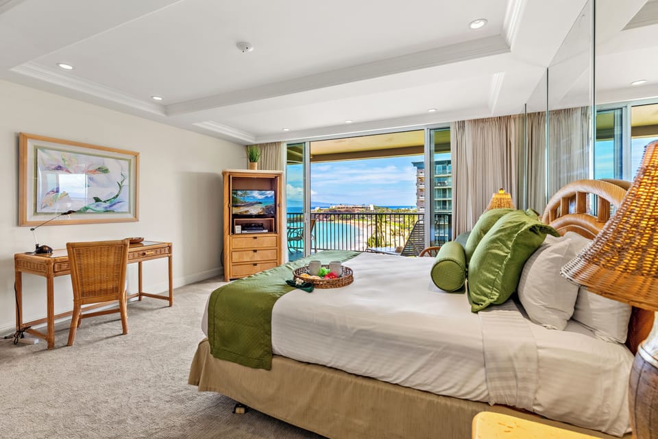 Spacious island-inspired retreat featuring a comfortable king-size bed, rich wood furnishings, cozy tropical accents, and a bright inviting bedroom space.