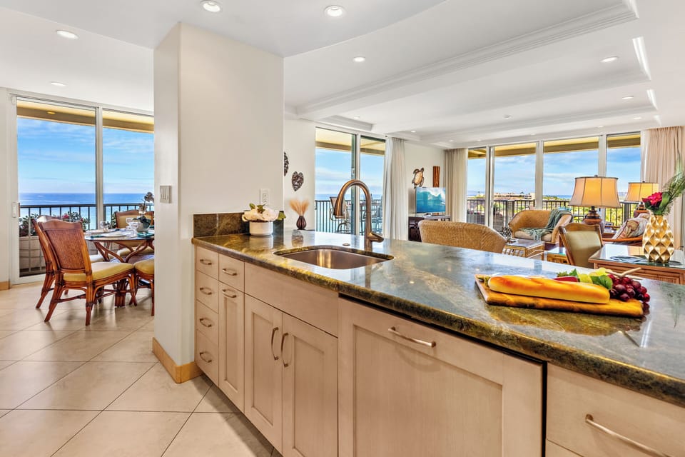 Stylish interior with refined finishes, granite countertops, and an open-concept design that flows seamlessly toward breathtaking ocean views and relaxed coastal living.