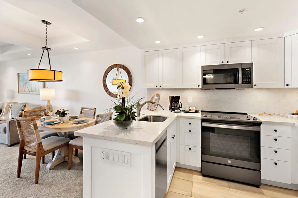Designed for effortless resort-style living, this bright and elegant kitchen features modern finishes, stainless steel appliances, and an open, inviting layout perfect for everything from leisurely island breakfasts to sunset cocktails after a day in parad