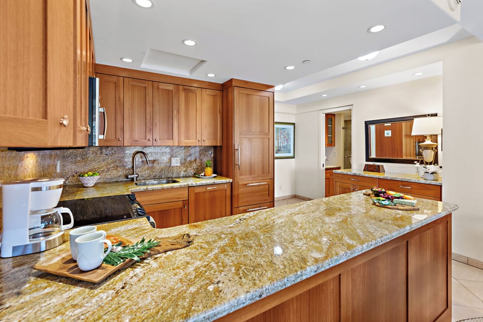 Your gourmet kitchen awaits with rich wood cabinetry, counters, and stainless-steel appliances. Perfect for preparing memorable meals together.