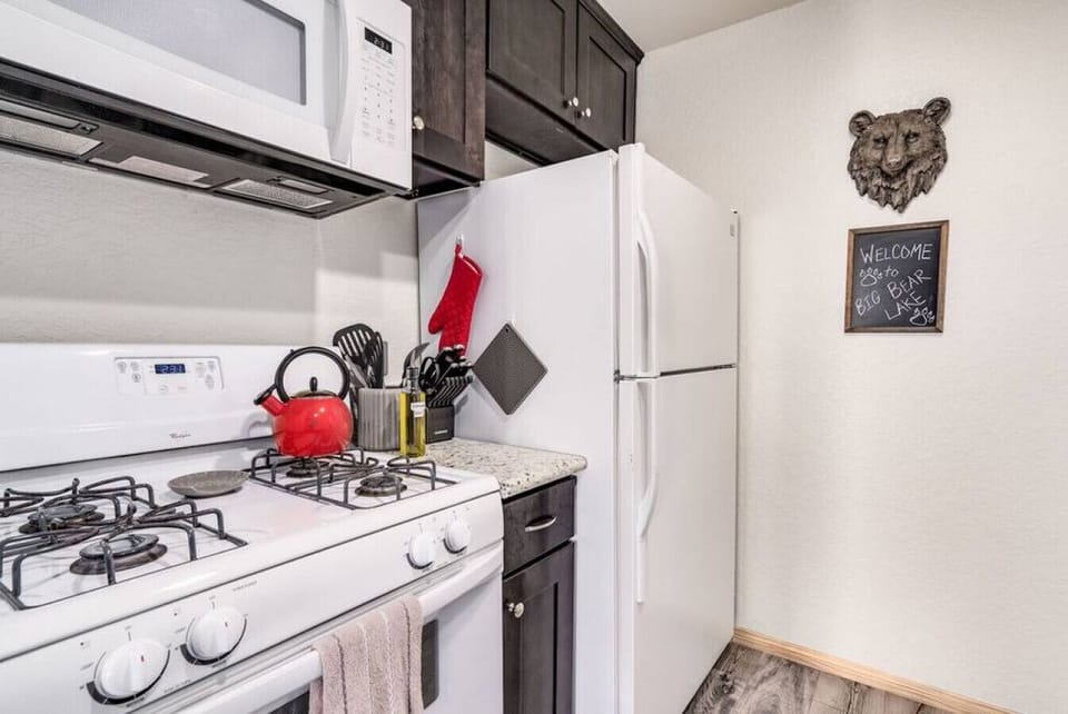 A nice modern open concept kitchen welcomes you to Big Bear Lake.  The Kitchen is fully stocked with everything you need even a cute red teapot to brew yourself a nice cup of luxury tea.