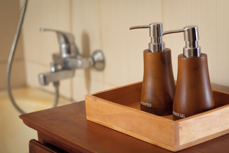 Signature Suite, 1 King Bed, Mountain View | Bathroom amenities | Separate tub and shower, rainfall showerhead, slippers, towels