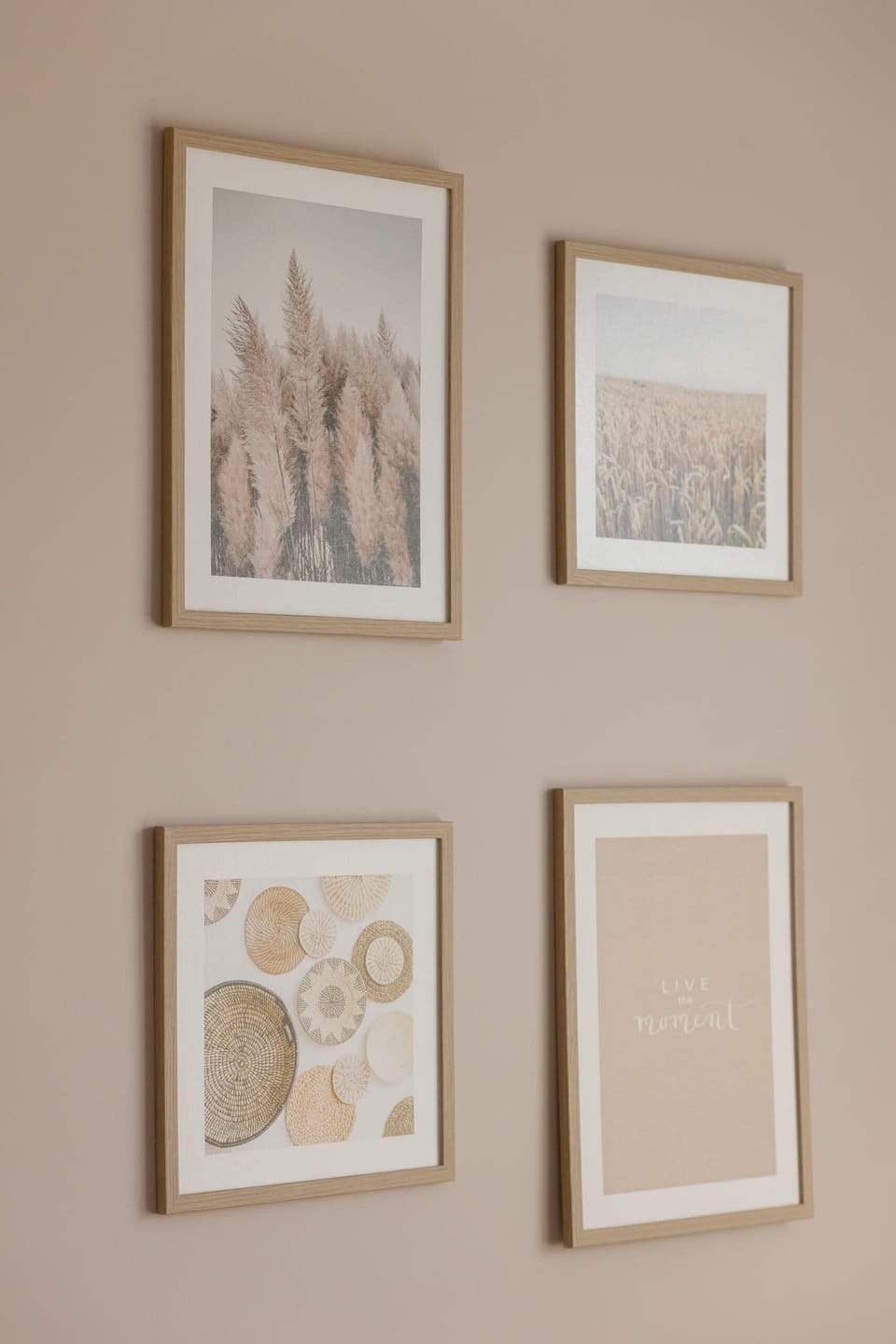 A simple wall with framed artwork, adding a personal touch to the minimalistic interior design.
