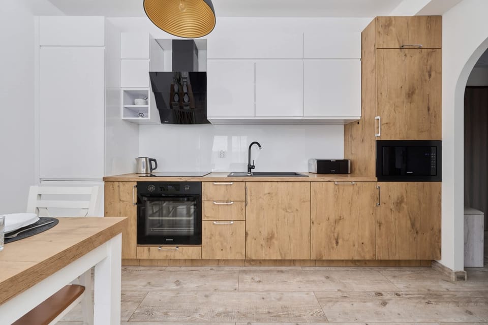 The sleek design of the kitchenette blending seamlessly with the living area.