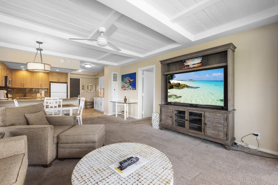 Unwind in your spacious living area with coastal decor, comfy seating, and modern entertainment—perfect for relaxing after a day of exploring or dining in your fully equipped kitchen.