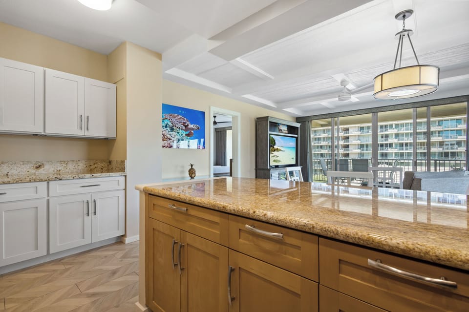 Your fully-equipped kitchen features gleaming granite countertops, ample cabinet space, and an open layout that flows seamlessly into the dining area—perfect for preparing meals while enjoying balcony views.