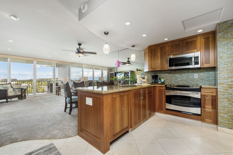 Prepare your favorite meals in this spacious kitchen with modern appliances and a large island, while soaking in the stunning views through the floor-to-ceiling windows.