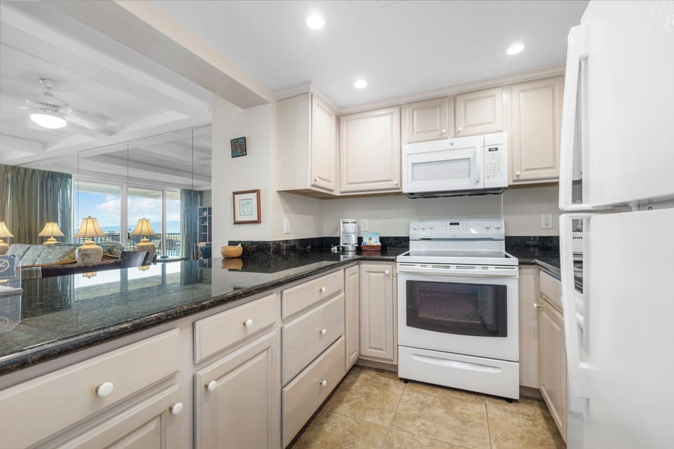Fully equipped kitchen with modern appliances, sleek granite countertops, and plenty of storage space for your culinary adventures during your stay.