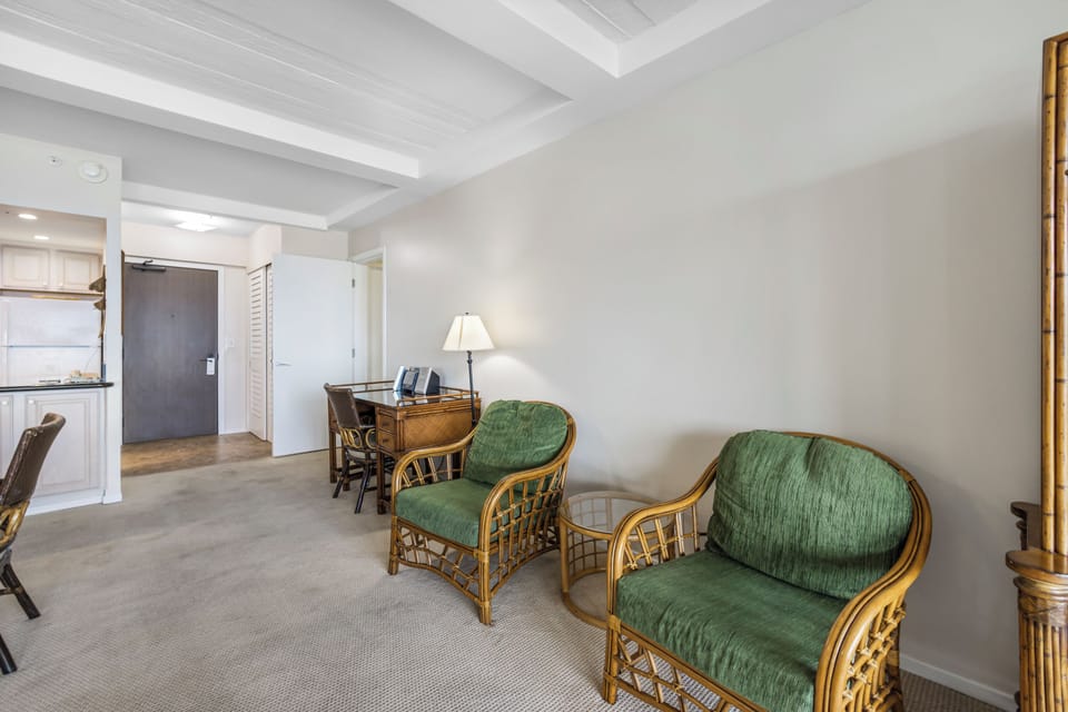 Your airy living space invites relaxation with comfortable bamboo seating, high ceilings, and a tranquil atmosphere perfect for unwinding after exploring the area.
