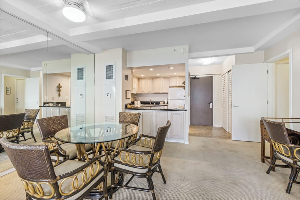 Relax in your open-plan living space with coastal-style dining and a fully-equipped kitchen, perfect for preparing meals during your stay.