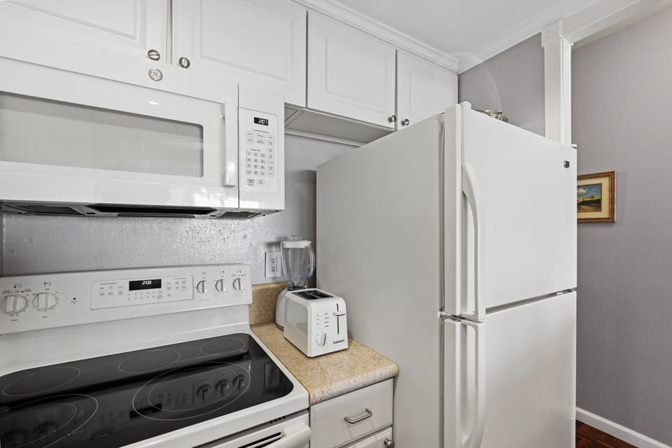 Your fully equipped kitchen has everything you need to whip up delicious meals, from a full-size fridge to a microwave and toaster—perfect for easy vacation dining.