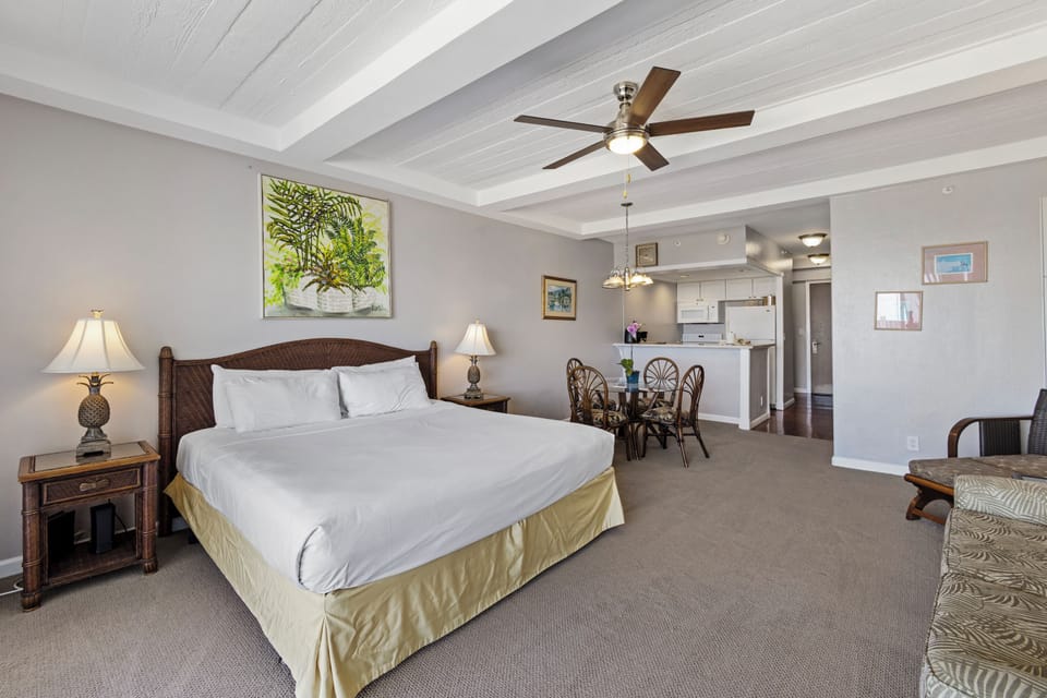 Sink into crisp linens and enjoy the breezy ceiling fan above your comfortable bed. Your open studio flows seamlessly into a dining nook and kitchen, perfect for your island retreat.