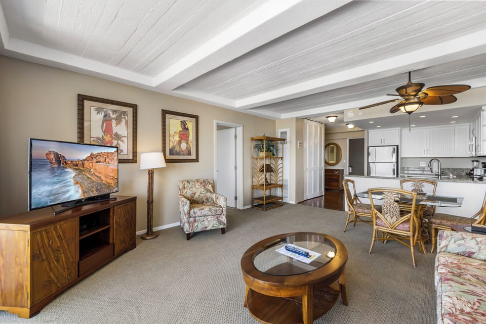 Step into your tropical-inspired retreat with soaring wood-beam ceilings, a cozy living space, and an open kitchen ready for island dining.