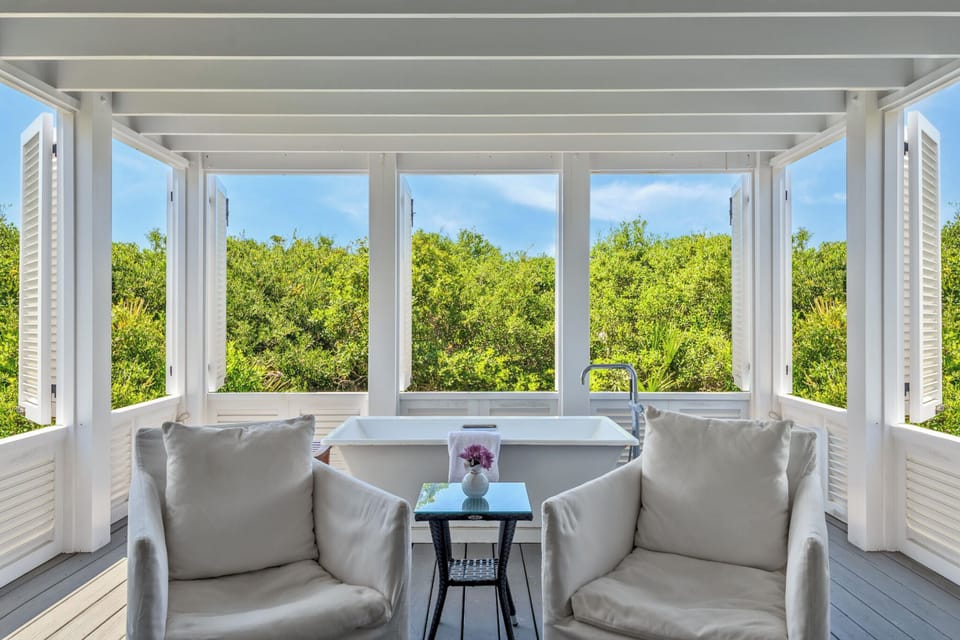 The downstairs covered back porch w/ soaking tub, an extension of the bedroom.