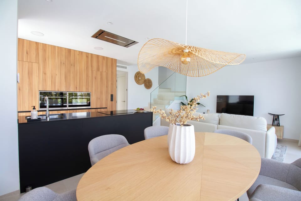 Dining area with open kitchen and living room
