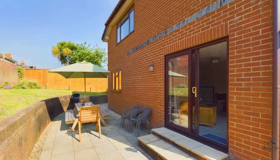 A second angle of the sunny garden area, showcasing the secure space for children to play.