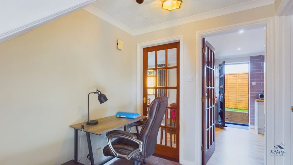 For those needing to check in while away, a dedicated study area with a desk and chair is provided.