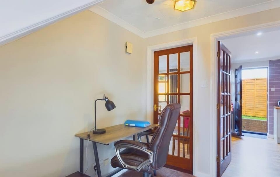 For those needing to check in while away, a dedicated study area with a desk and chair is provided.