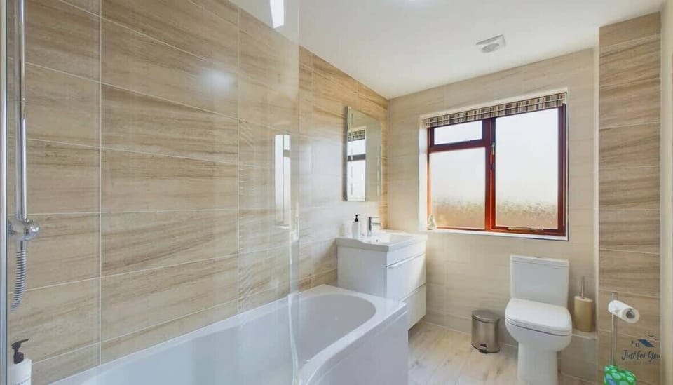 The main family bathroom features a full-sized bath, essential for families with young children on holiday.