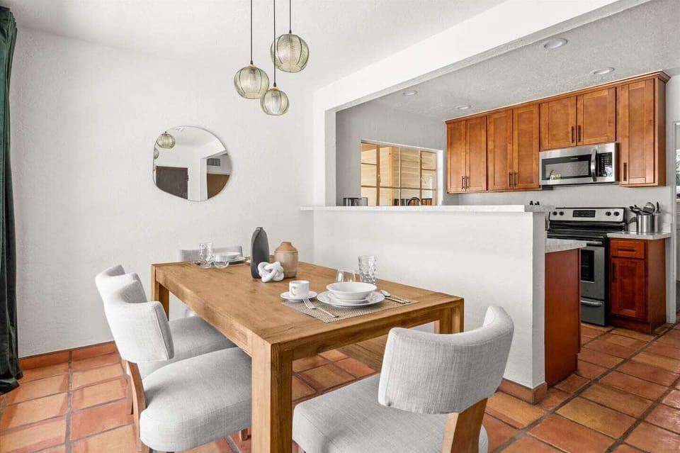 Dining room is conveniently located next to the kitchen. Kitchen is fully stocked with dishes, flatware, glasses, placemats and cookware.