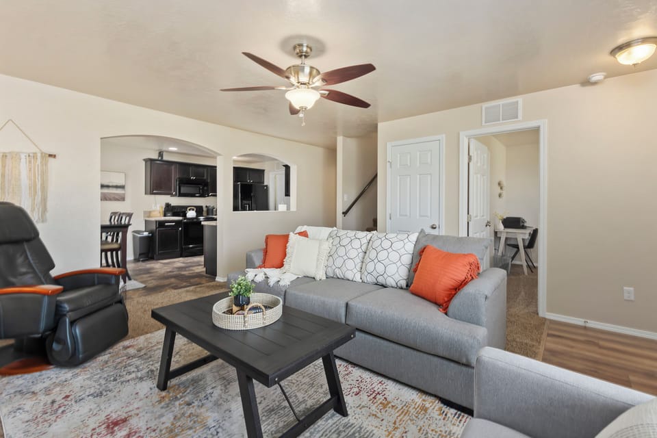 Seamless living! The open-concept living area effortlessly connects to the kitchen and is adjacent to a downstairs bedroom. Ideal for the working traveler, the bedroom features a twin-size bed, desk, and printer. Comfort and convenience in one space! 