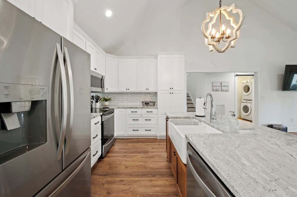 Kitchen With Granite Countertops, A Large Island and SS Appliances