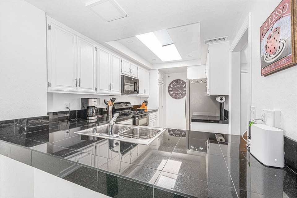 The kitchen comes stocked with dishes, utensils, cookware, bakeware, and major and small appliances.
                