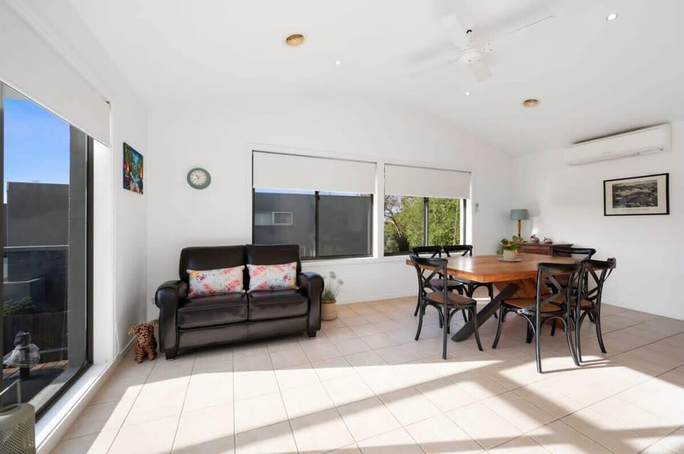 Upstairs, the family room and adjoining meals area flow outside to the sunny deck, creating a perfect space for socialising and relaxation