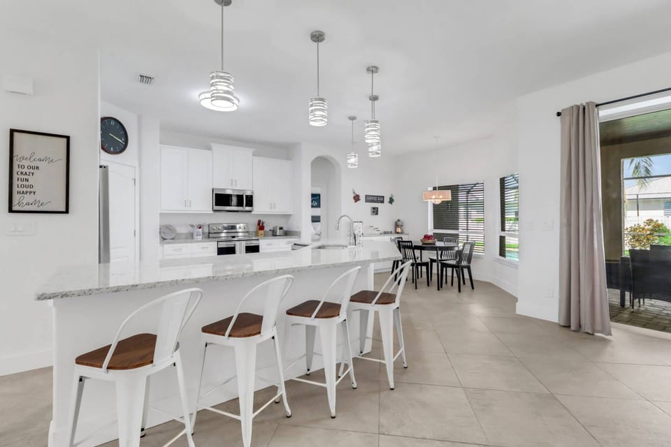 A beautiful quartz eating counter with barstools separates the open kitchen from the living room.