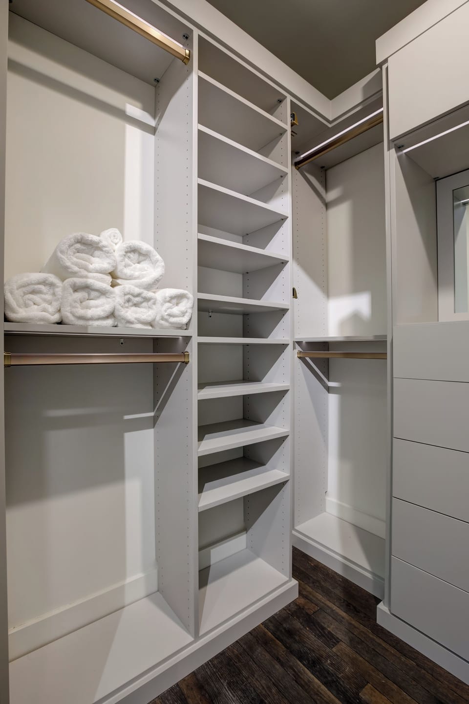 Closet shelving stocked w/ fresh towels & ample storage space