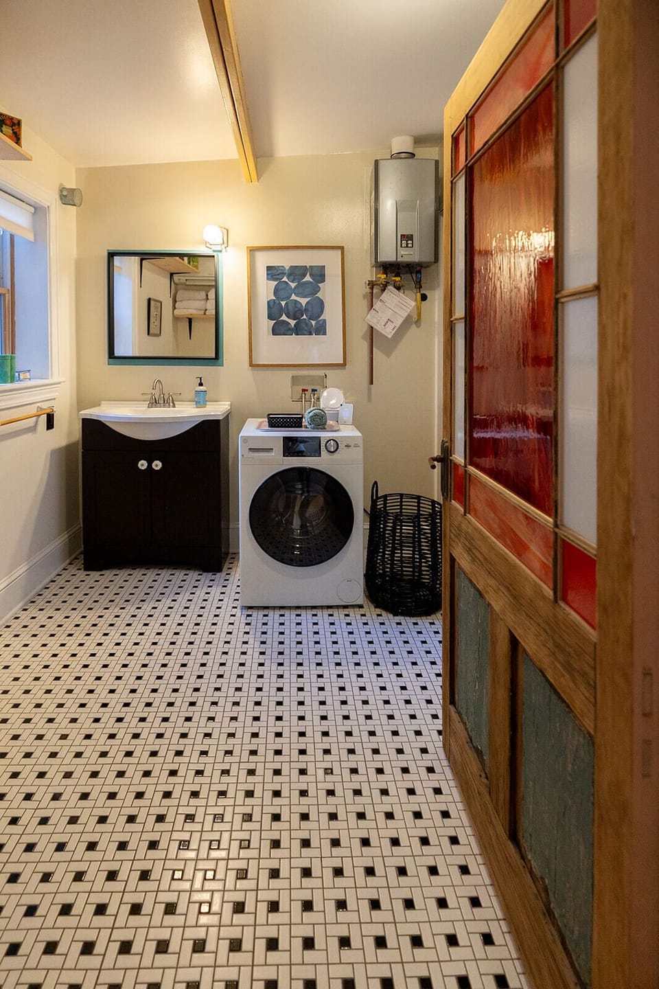 Dirty laundry? Shake it off and get it clean here in our euro-style washer/dryer combo unit in our super spacious bathroom with a custom vintage door