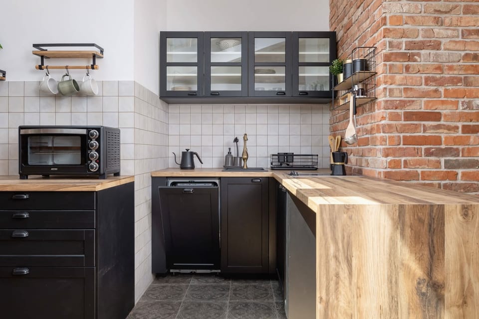 The sleek design of the kitchenette blending seamlessly with the living area.