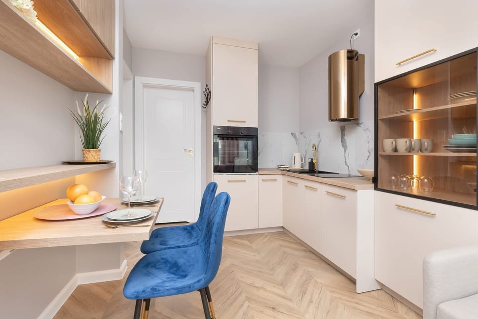 The sleek design of the kitchenette blending seamlessly with the living area.