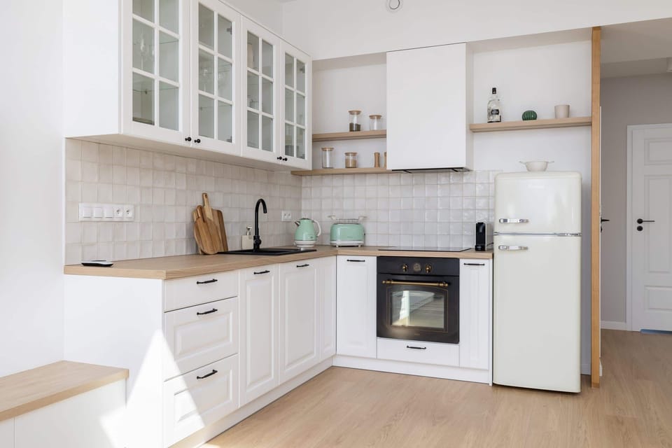The sleek design of the kitchenette blending seamlessly with the living area.