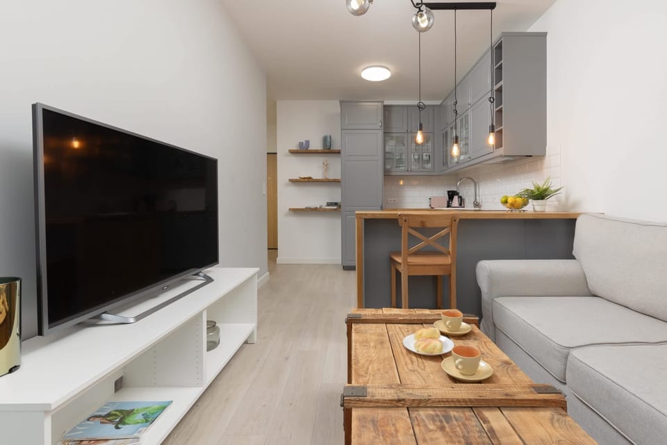 The living room's modern and stylish decor creates a welcoming atmosphere. 