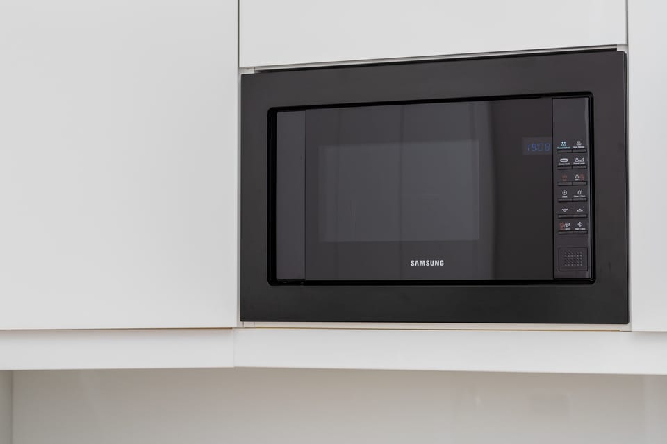A close-up of the kitchen appliances, including a microwave highlighting its functionality.