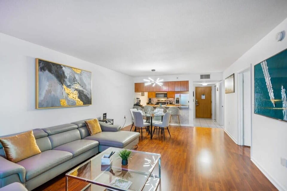 Open-concept living and dining area with modern furnishings and hardwood floors.