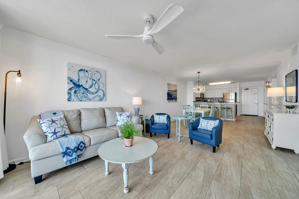 Sink into coastal comfort in your open-plan living space, where soft blues and whites create the perfect seaside retreat atmosphere.