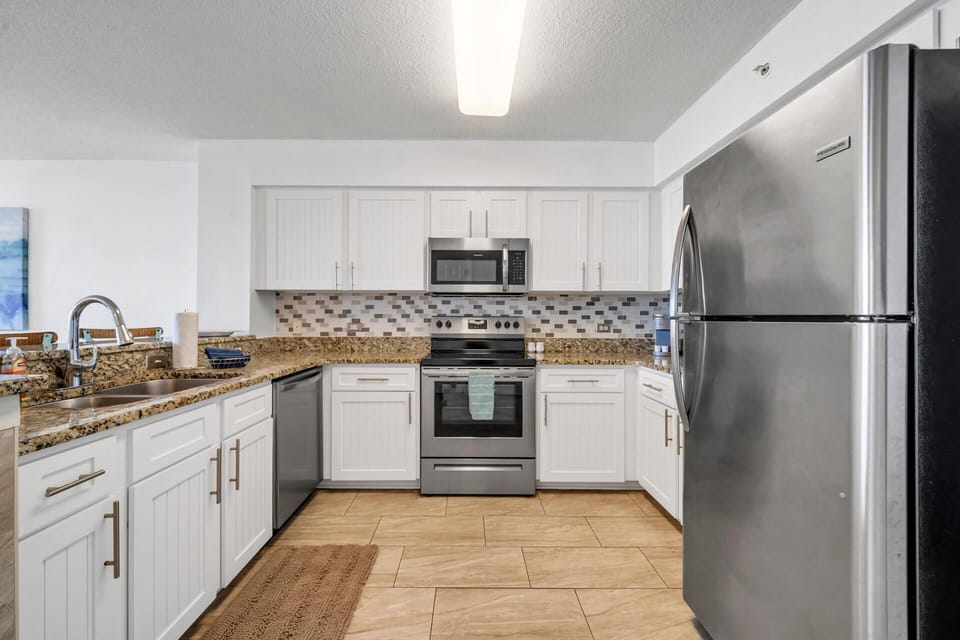 Your fully equipped kitchen features granite countertops, stainless steel appliances, and everything you need to create memorable meals during your stay.