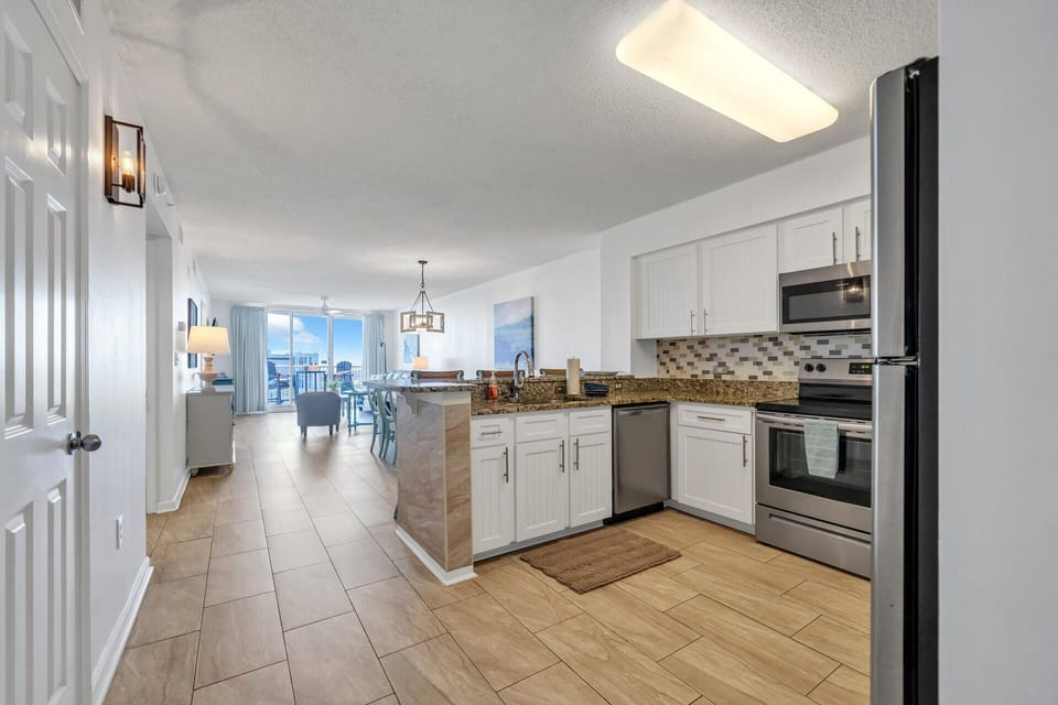 Prepare meals in your fully-equipped kitchen with granite countertops, stainless appliances, and stunning city views beyond.