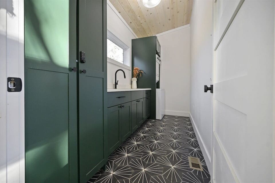 Laundry Room: Stylish storage and sleek design make washing a breeze in this chic space!