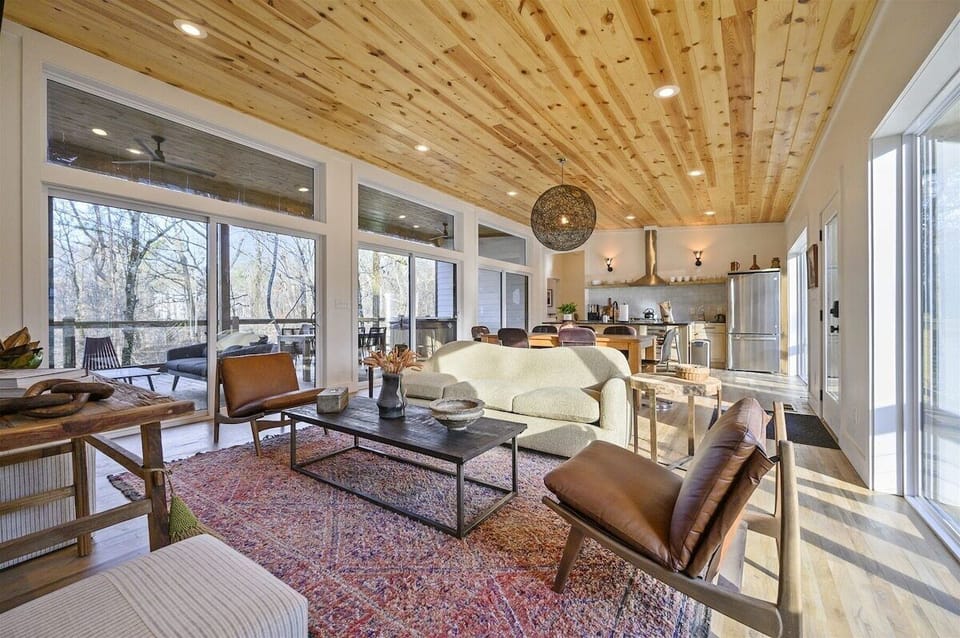 Living Room: Experience nature's beauty through expansive windows amidst stylish furnishings!