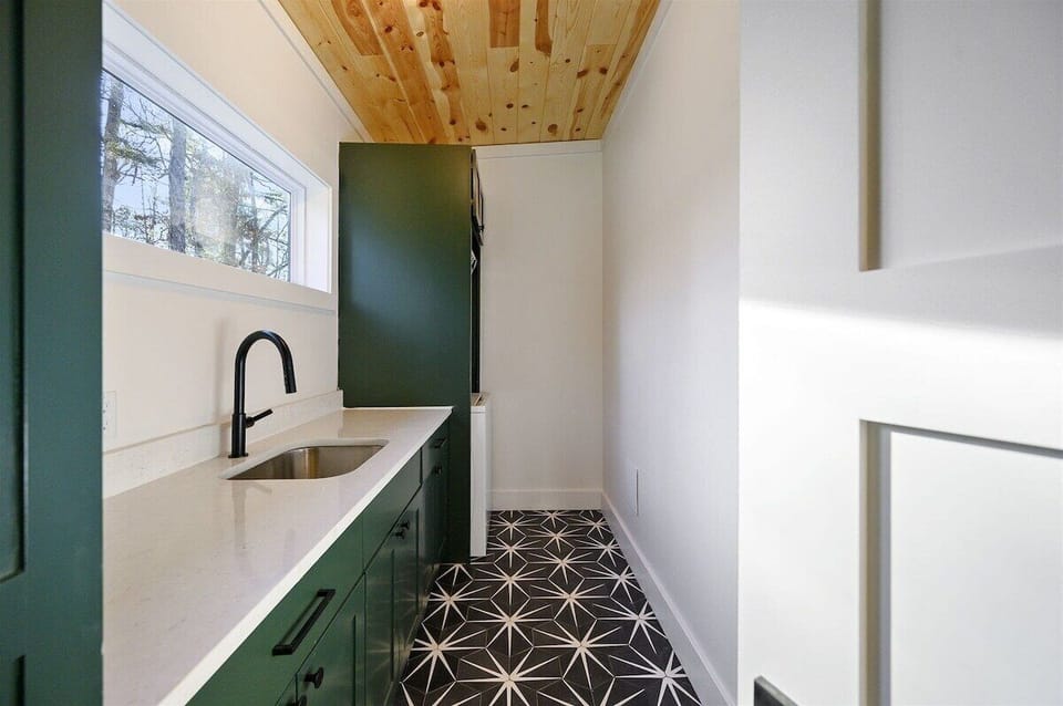 Laundry Room: Sleek design with modern appliances and a stylish patterned floor! Ideal for upkeep!