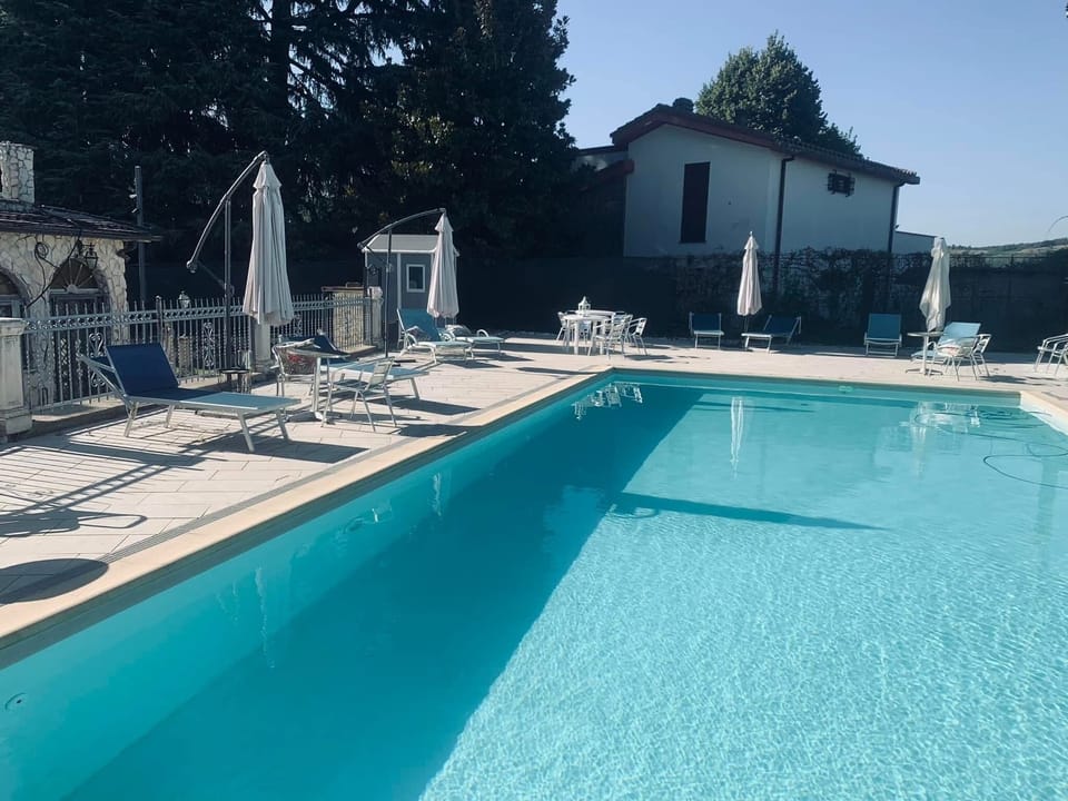 Seasonal outdoor pool, open 9:00 AM to 7:00 PM, pool umbrellas