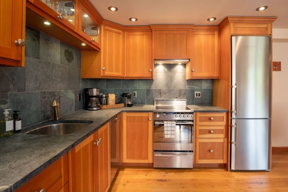 The kitchen comes equipped with a fridge, stove, dishwasher, coffee maker, toaster, and french press!